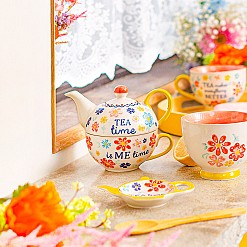 Teekanne mit integrierter Tasse und Blumendesign